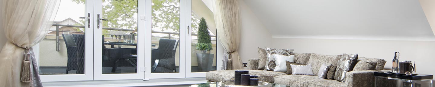 Interior photo of a living room with a French-style patio door. Renoviso installs Harvey, Pella, and Andersen brands.