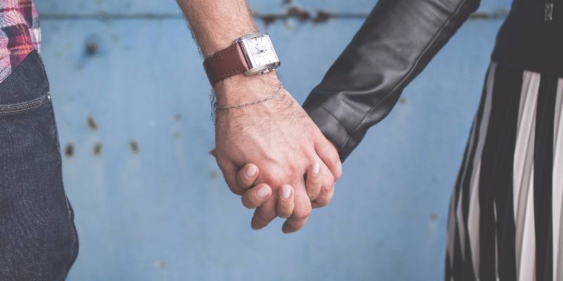 Man and woman holding hands.
